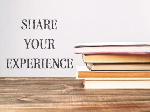 A stack of books with the words share your experience written on top Foto stock