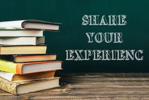 Stack of books with the words share your experience written on top Stock Photos
