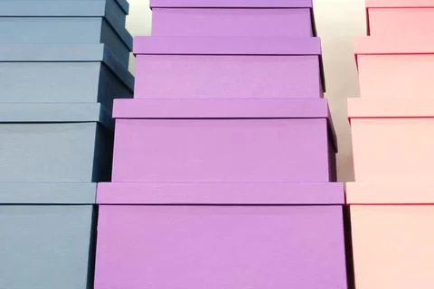 Stack of boxes with purple and pink boxes on top of each other. The boxes are Stock Photos