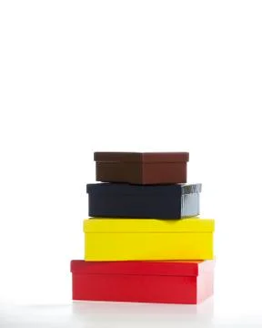 Stack of boxes - red, yellow, black, brown Stock Photos