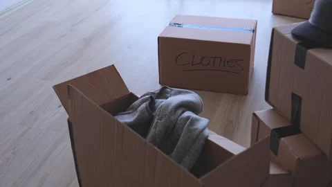 A stack of boxes with the words books and clothes written on them. New house Stock Footage 315700586
