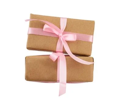 Stack of boxes wrapped in brown kraft paper and tied with a pink ribbon Stock Photos