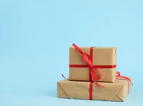 Stack of boxes wrapped in brown paper and tied with a red bow Foto stock