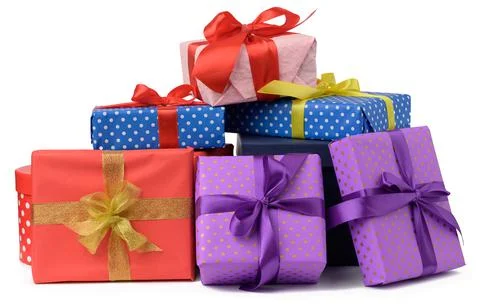 Stack of boxes wrapped in paper and tied with a silk ribbon on a white backgr Stock Photos