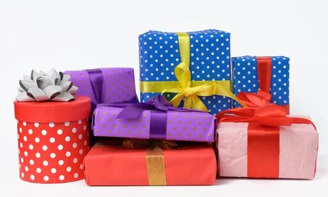 Stack of boxes wrapped in paper and tied with a silk ribbon on a white backgr Foto stock
