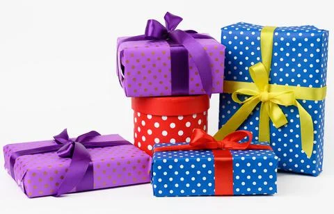 Stack of boxes wrapped in paper and tied with a silk ribbon on a white backgr Stock Photos