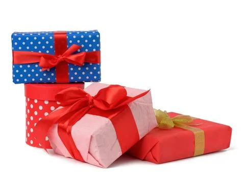 Stack of boxes wrapped in paper and tied with a silk ribbon on a white bac... Foto stock