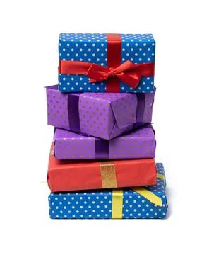 Stack of boxes wrapped in paper and tied with a silk ribbon on a white bac... Stock Photos