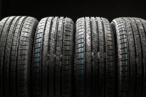 Stack of brand new high performance car tires on clean low-key black studio.. 스톡 사진