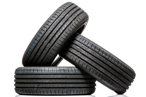 Stack of brand new high performance car tires on clean high-key white studio  스톡 사진