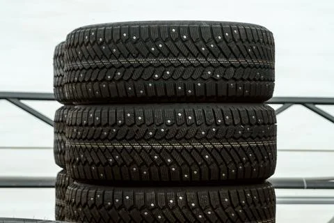 Stack of brand new studded winter tires close up with deep rubber tread for.. 스톡 사진