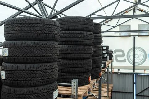 Stack of brand new winter car tires close up with focus on deep rubber trea.. 스톡 사진