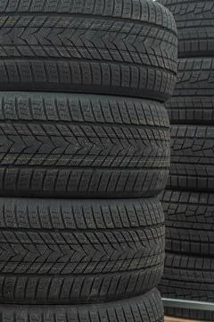 Stack of brand new winter car tires close up with focus on deep rubber trea.. 스톡 사진