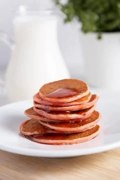 Stack of breakfast pancakes with jam raspberry on light background Stock Photos