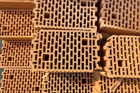 A stack of bricks made of red light clay. Environmentally friendly building m 写真素材
