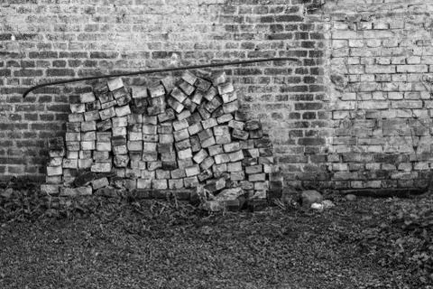 Stack of bricks piled near an old wall in an old european city Stock Photos