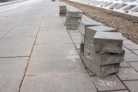 Stack of bricks on the sidewalk. Pavement renewal project in the city. Stock Photos