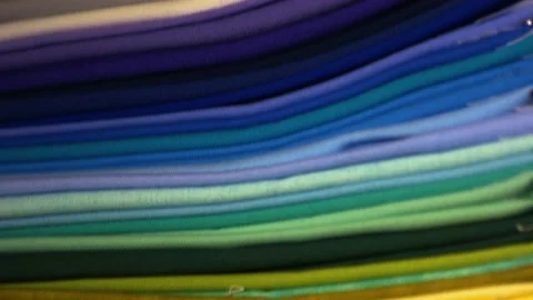 Stack of bright folded clothes of various colors. Stock Footage 162963924