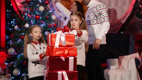 Stack of bright gift boxes near Christmas tree. Family celebrate New Year  Stock Footage 164115524