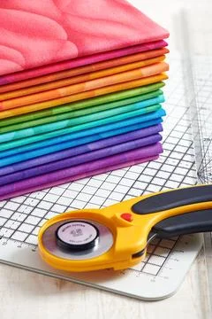 Stack of bright multicolored fabrics, accessories for quilting Stock Photos