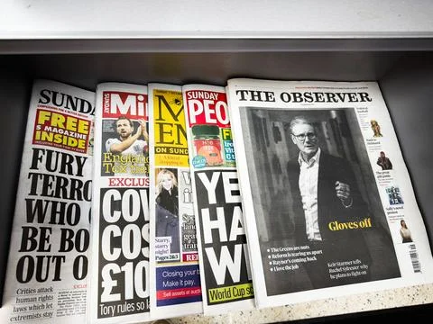 Stack of British newspapers in a Manchester box featuring The Observer and .. Foto stock