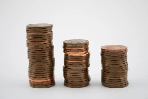 Stack of bronze coins on white background. Coins of five euro cents. Stock Photos