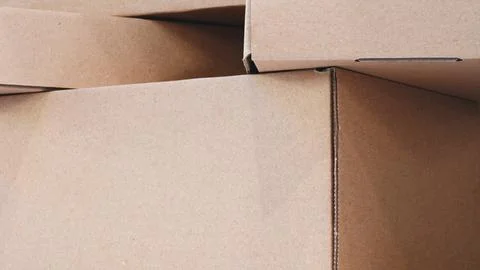 A stack of brown cardboard boxes as background for template pages and banners Stock Photos