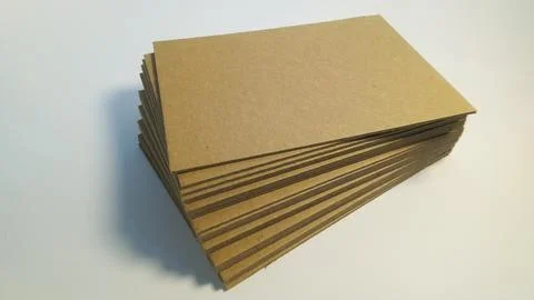 Stack of brown cardboard sheets on white background. Stock Photos