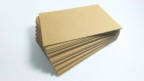 Stack of brown cardboard sheets on white background. Stock Photos