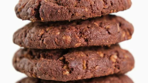 Stack of brown cookies appearing on white background. American food concept Stock Footage 220191018