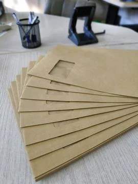 Stack of brown craft envelopes on a desk Stock Photos