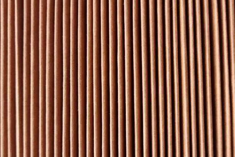 Stack of brown kraft paper envelopes viewed from side with vertical fold lines Stock Photos