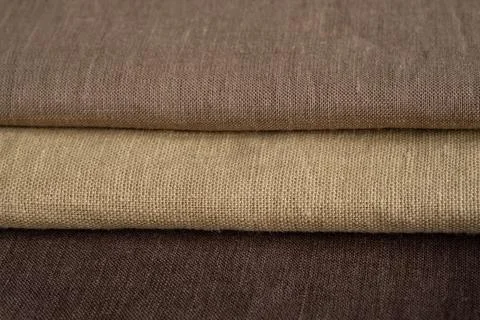 Stack of brown linen fabrics, close up Stock Photos