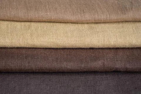 Stack of brown linen fabrics, close up Stock Photos