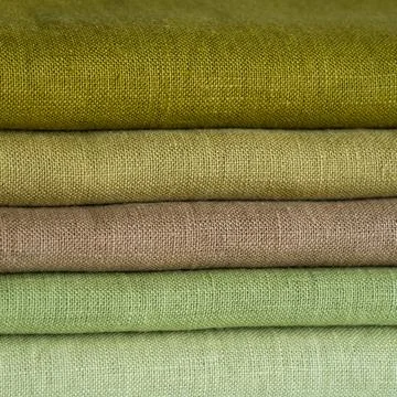 Stack of brown linen fabrics, close up Stock Photos