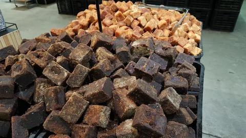 A stack of brown palm sugar cubes or gula merah for sale at supermarket 스톡 사진