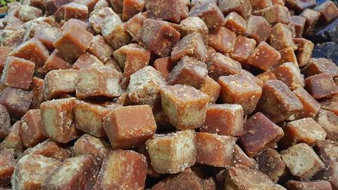 A stack of brown palm sugar cubes or gula merah for sale at supermarket Stock Photos