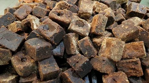 A stack of brown palm sugar cubes or gula merah for sale at supermarket 스톡 사진