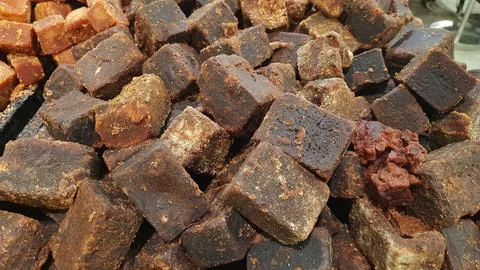 A stack of brown palm sugar cubes or gula merah for sale at supermarket Stock Photos