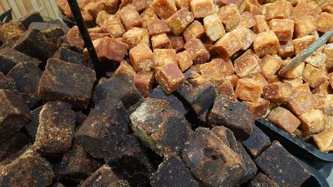 A stack of brown palm sugar cubes or gula merah for sale at supermarket 스톡 사진