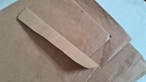 Stack of brown paper sheets. Recycled craft paper texture for packaging and Stock Photos