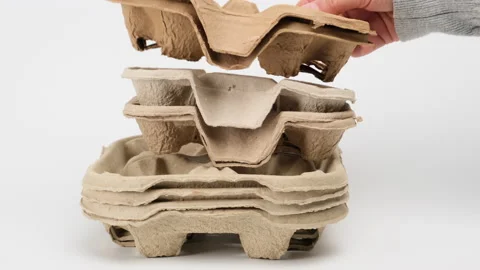 Stack of brown paper takeaway beverage holders on a white background, close up Stock Footage 147548748