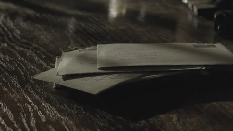Stack of Brown Stamped Envelopes on Dark Table Evoking Payment Demands Stock Footage 346848154
