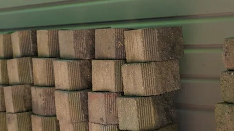 A stack of builder bricks lined up in the shade for storage. Vídeos de archivo 340923248