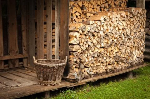 Stack of burnng wood with an old basket Stock Photos