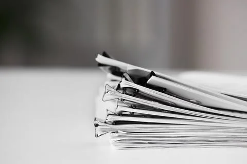 Stack of business documents with binder clips, office organization and paperw Stock-Fotos