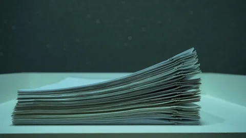 Stack of Business Documents With Metal Paper Clips Appears on a White Desk Stock Footage 320322695