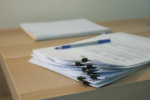 Stack of business documents on office desk Stock Photos