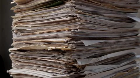 Stack business paper on desk, paperwork in office. Piled heap high documents Stock Photos