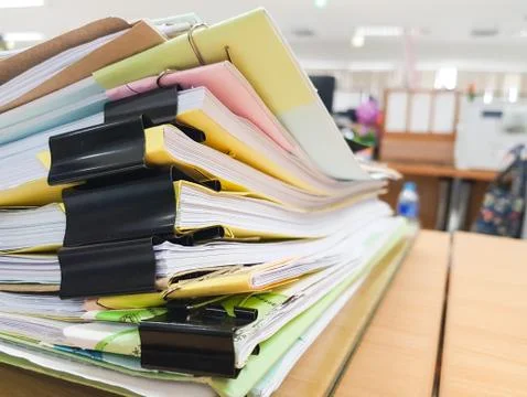 Stack of business paper documents on office background. Stock Photos